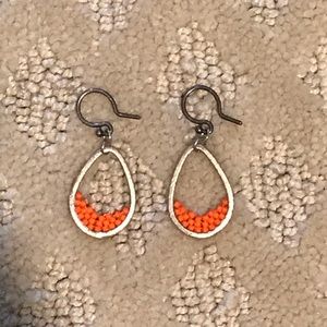 silver oval hoop earrings with orange accent